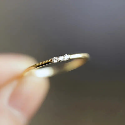 Product view showing ultra-slim three-stone ring