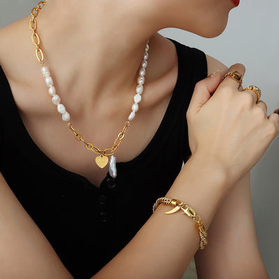 Model wearing pearl gold link necklace LOVE heart baroque drop