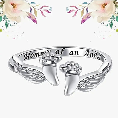Product view showing silver-tone engraved angel wings and baby feet open ring