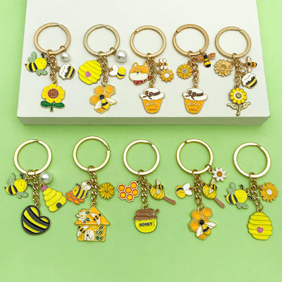 Image 1 showing a box with several key chains and some charms.