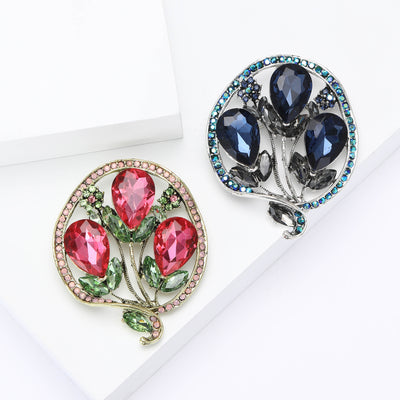 Front view of three faceted tulip blooms inside a round crystal frame