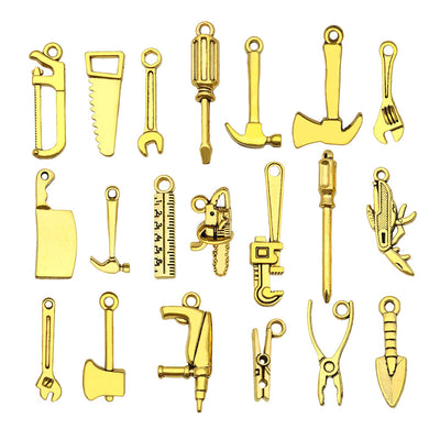 Gold-tone assorted shape charms arranged on a light background