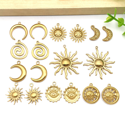 Gold-tone sun and moon charms arranged on a light background