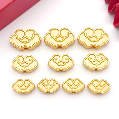 Matte gold-tone spacer bead beads arranged on a light background