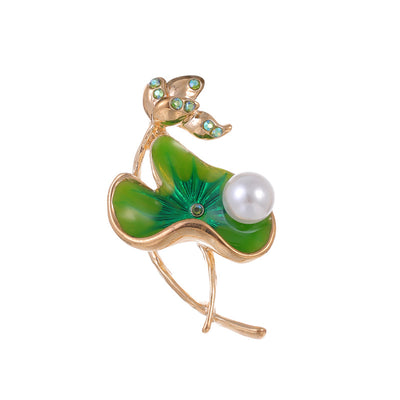 Front product view of an emerald green enamele ring with pearl and diamond