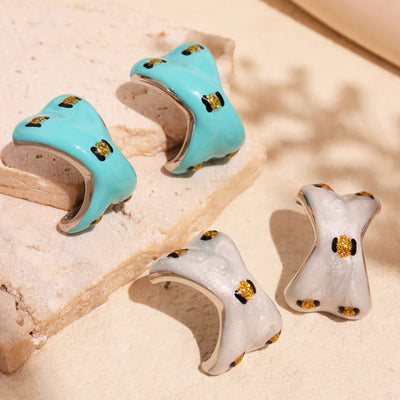 Mint and pearl white enamel C studs on stone with metal rims