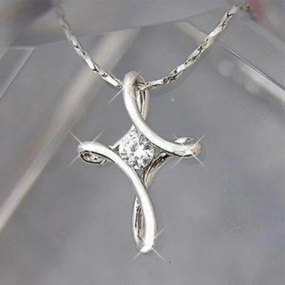 Silver twisted cross pendant with clear center stone on twisted chain