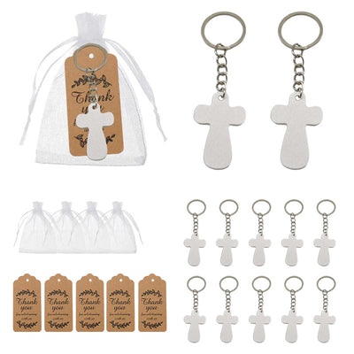 White cross keychains displayed beside organza bags and kraft thank-you tags.