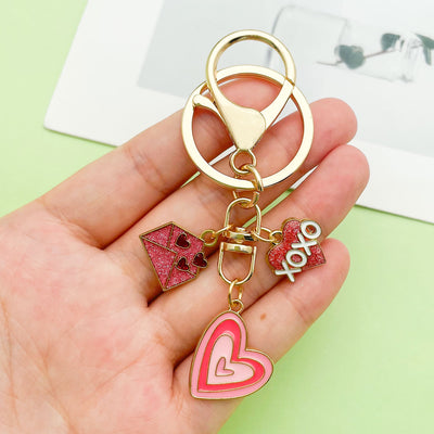 Image 1 showing a person holding up two different key chains.