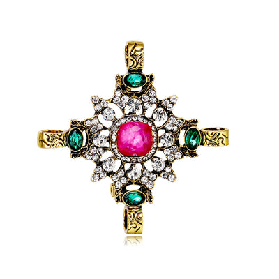 Front product view of the cross brooch pin in gold and silver