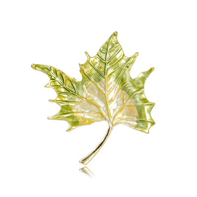 Front product view of the maple leaf brooch pin in gold and yellow