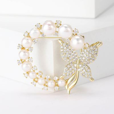 Gold pearl butterfly wreath brooch front on white