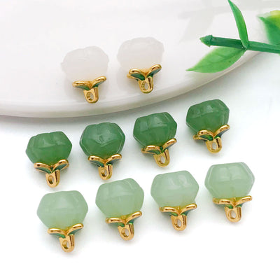 Front product photo of jade-look glass pumpkin charm showing the pictured design arrangement