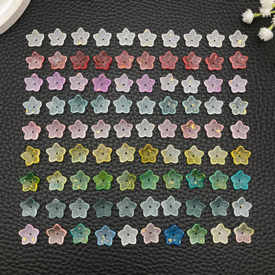 Multicolor flower charms arranged on a light background