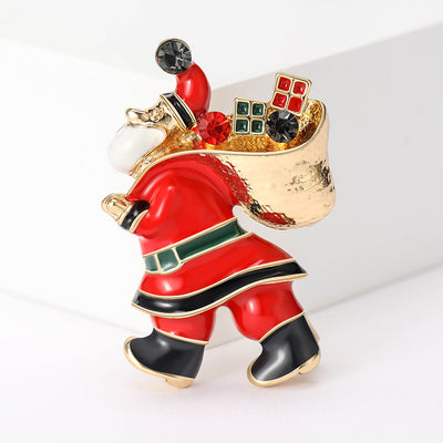 Red enamel Santa Claus brooch carrying gold gift bag