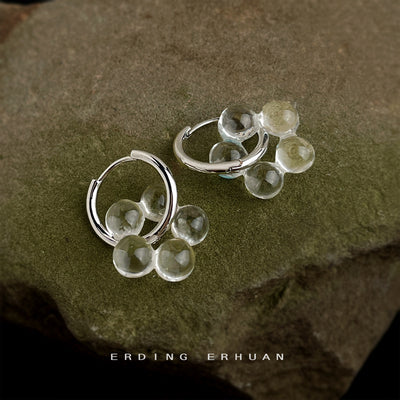 Silver-tone translucent-disc flower hoop earrings in the first product display.