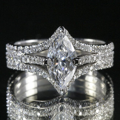 Product view showing silver-tone marquise clear solitaire triple-row split-band ring