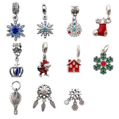 Colorful snowflake and christmas stocking charms arranged on a light background