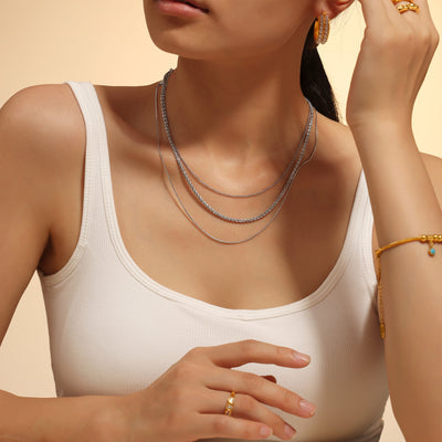 Steel triple layer sparkle curb snake necklace worn on model