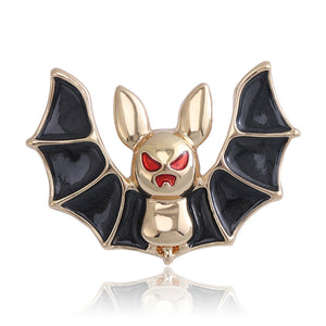 Black Wing Bat Brooch with Gold Tone Body and Red Eyes