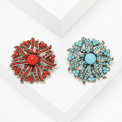 sunburst turquoise or red beaded flower brooch crystal pin isolated on a white background