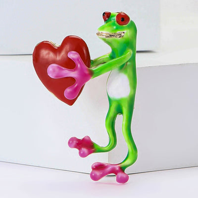 frog holding a heart brooch shown from the front
