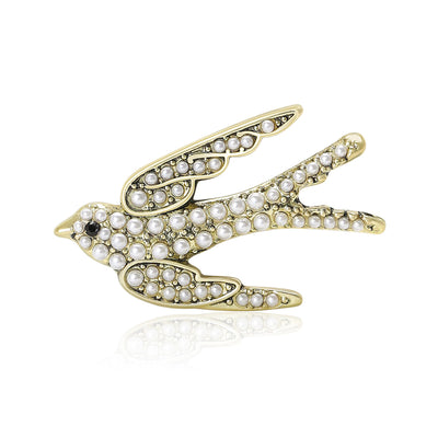 Antique bronze pearl swallow brooch front on white