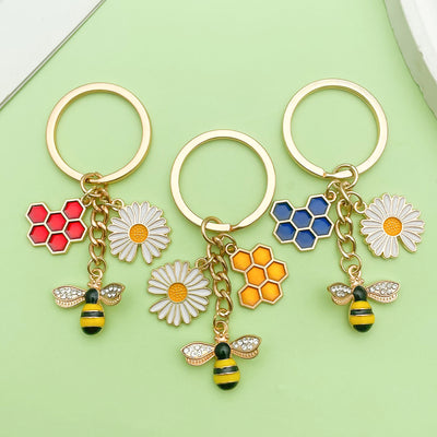 Image 1 showing three key chains with bee and flower charms.