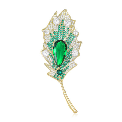 Green teardrop crystal pave gold leaf brooch front on white