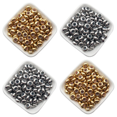 Metallic crimp bead jewelry findings arranged on a light background