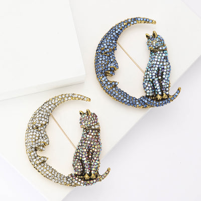 crystal cat sitting on crescent moon brooch group view
