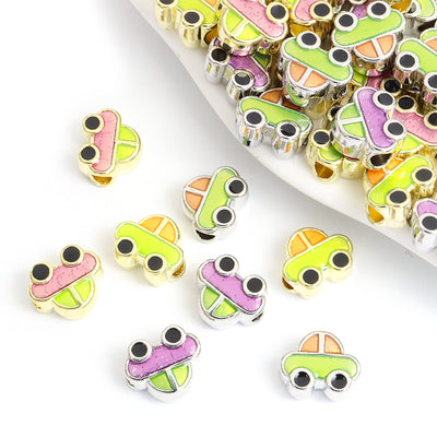 Assorted car spacer beads arranged on a white background