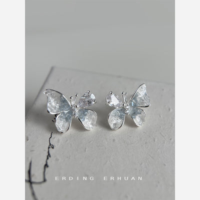 Silver-tone clear-gradient butterfly studs in the first product display.