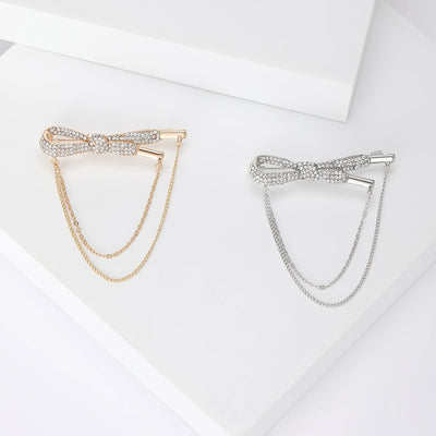 Front view of the crystal bow chain brooch in gold or silver tone with polished metal detail on a white background