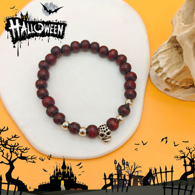 Dark red wood skull stretch bracelet on white stone with Halloween graphics