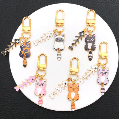 Overview showing the available color and design variations of the cat and fish bone metal clasp keychain