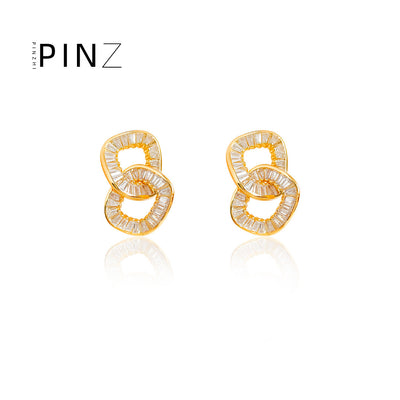 Gold interlocked oval baguette CZ stud pair on white bg
