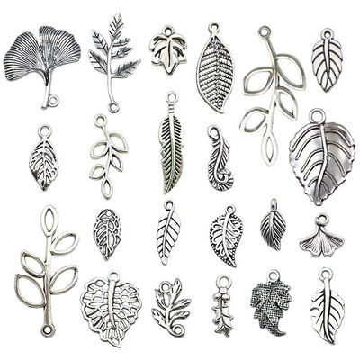 Metallic leaf charms arranged on a light background
