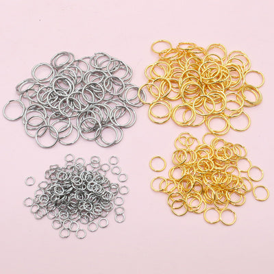 Overview of round jump rings grouped by size in gold and silver-tone finishes arranged on a light background