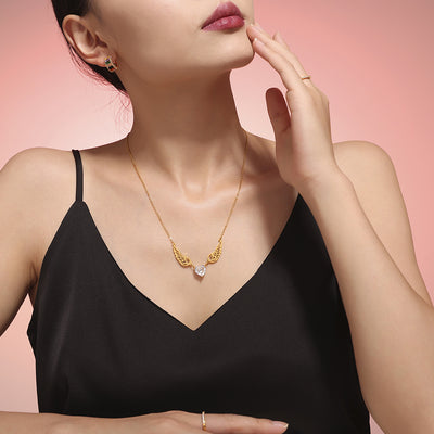 Model wearing gold angel wing heart zircon pendant necklace