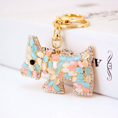 Close view of a dog-shaped charm decorated with pastel oval accents and clear rhinestone edging.