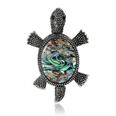 Front view of dark crystal turtle with an iridescent abalone style shell center