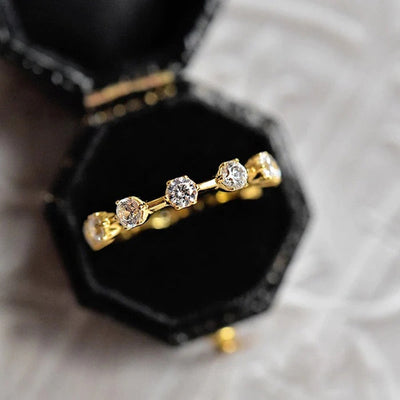 Gold five clear stone station thin band ring in black jewelry box