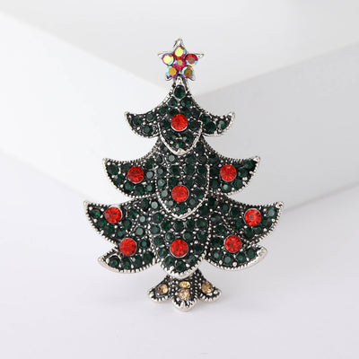 Front view of dark green tiered Christmas tree with red stones and a gold star