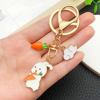 Overview showing the available color and design variations of the white and pink rabbit floral metal keychain