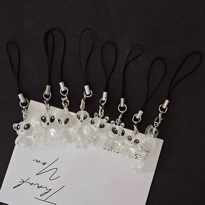Eight clear resin alien phone strap charms lined up on thank you card
