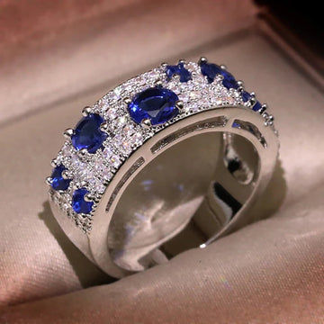 Wide Blue And Clear Round Stone Cluster Band In Silver Tone