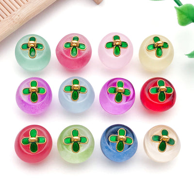 Clear apple charms arranged on a light background