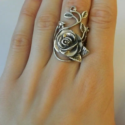 Product view showing large antiqued silver-tone sculpted rose vine ring
