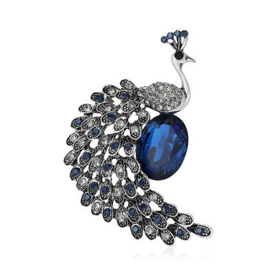 Front view of the dark blue crystal peacock brooch with curved tail decorative clothing pin on a white background